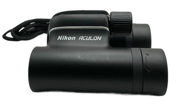 Black Nikon Aculon T01 binoculars shown from the side with focus knob and neck strap visible.