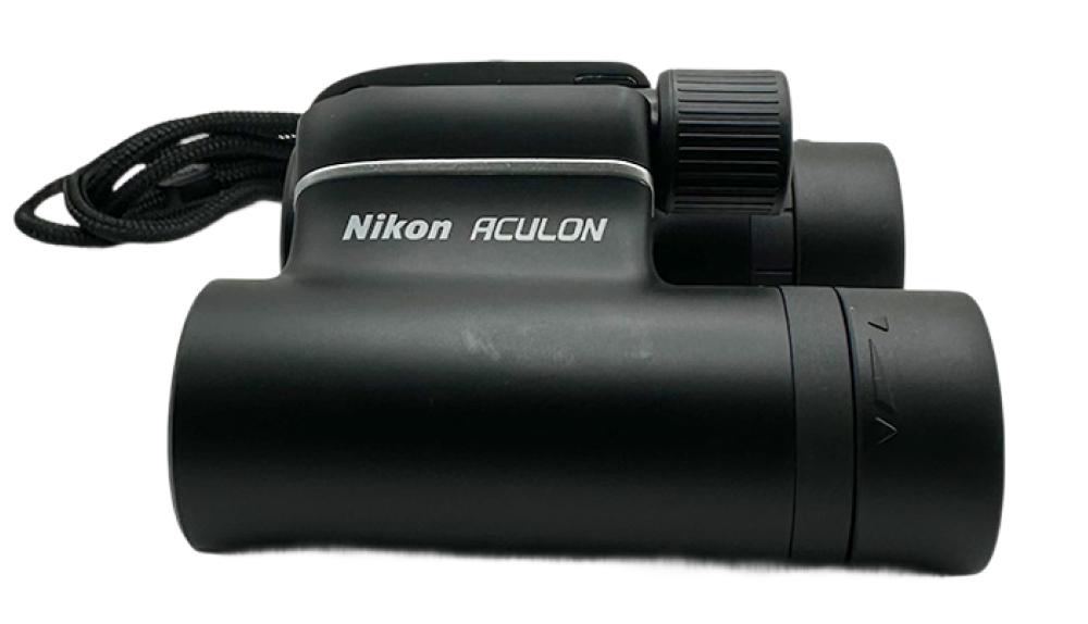 Black Nikon Aculon T01 binoculars shown from the side with focus knob and neck strap visible.