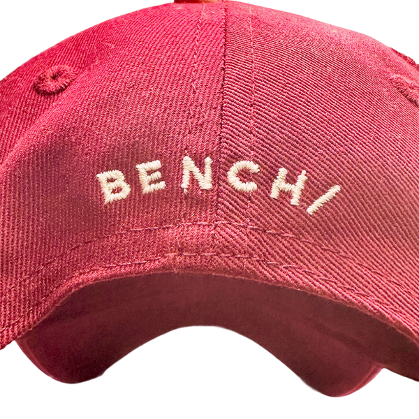 Red Bench baseball cap with white embroidered logo on the front.