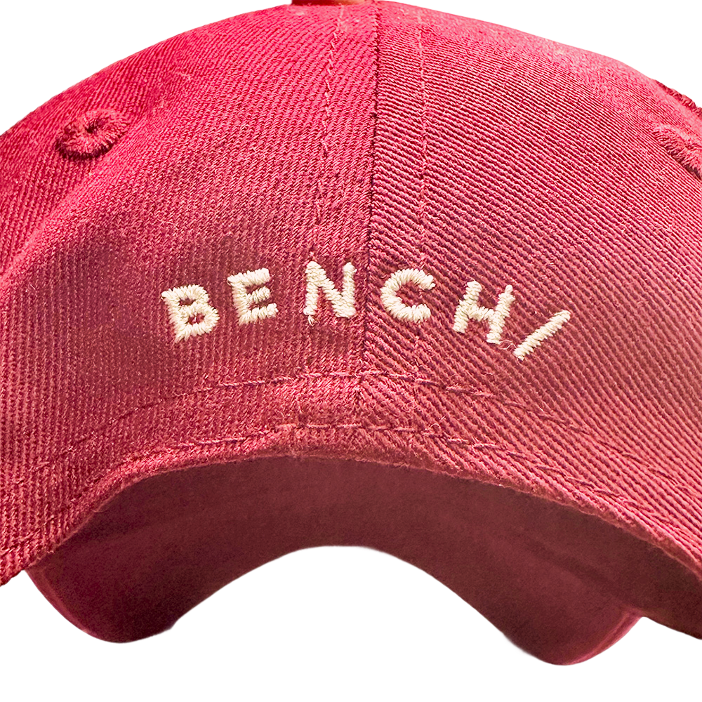 Red Bench baseball cap with white embroidered logo on the front.