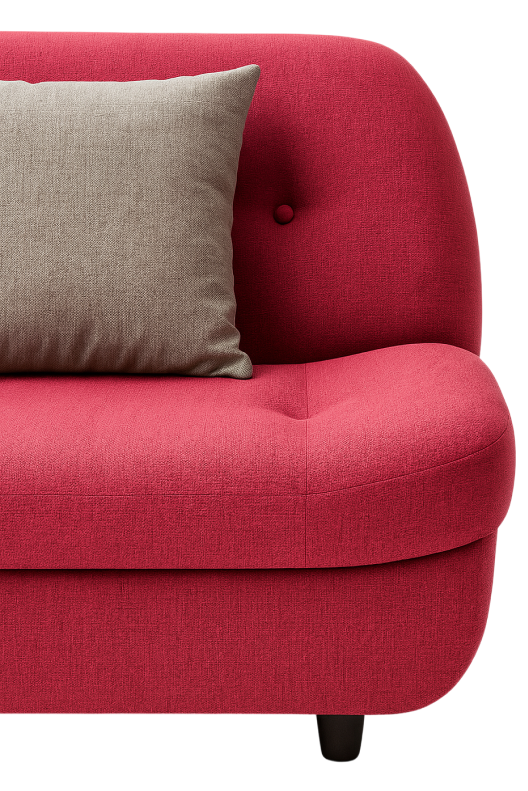 Close-up of a red modern sofa with curved edges and a light gray accent pillow on the seat.