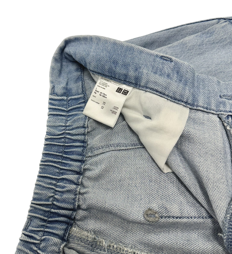 Close-up of the waistband and inner label of Uniqlo Women's Baggy Pants in light blue denim.