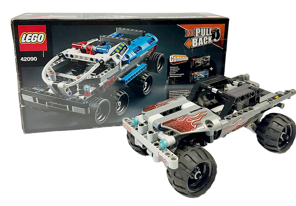 LEGO Technic 42090 set with the assembled stunt truck and its box shown in the background.