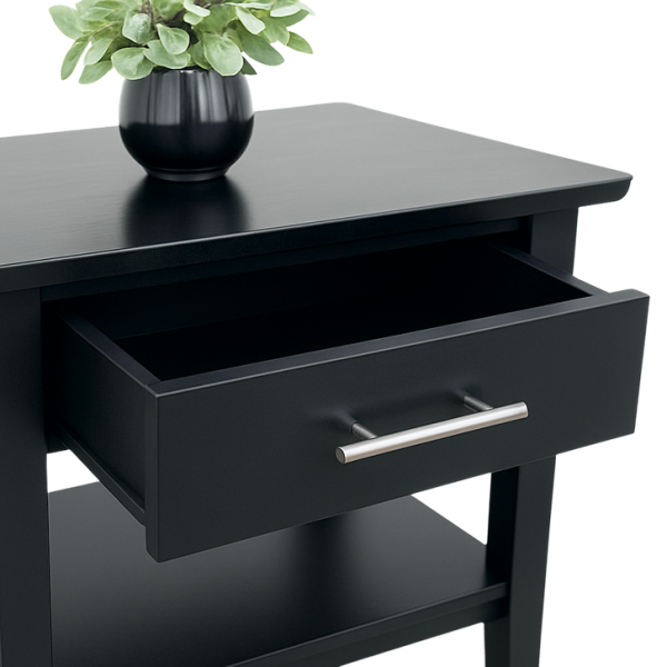 Sutton Black End Table with open drawer, metal handle, lower shelf, and a potted plant on top.