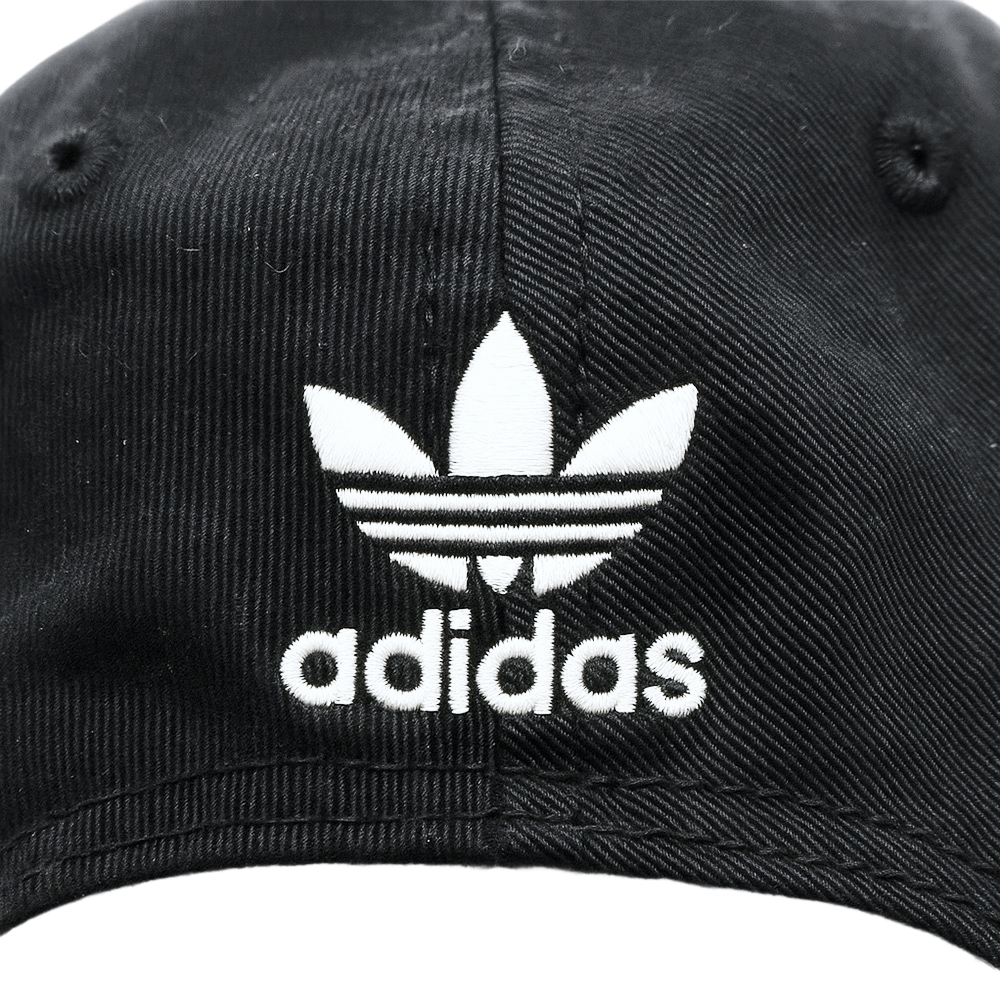 Close-up of a black Adidas Originals cap featuring the white Trefoil logo and "adidas" text on the front.