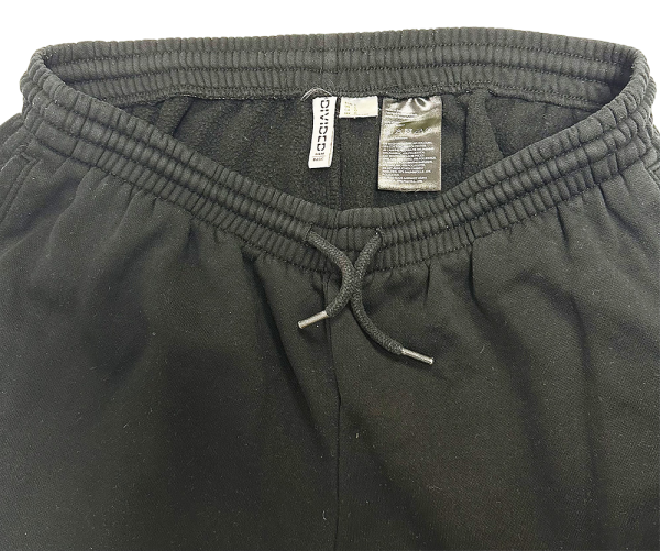 Close-up of H&M Women's Basic Sweatpants in black, featuring elastic waistband and drawstring.