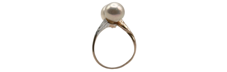 Gold-tone ring featuring a round white pearl set on a slender, textured band.