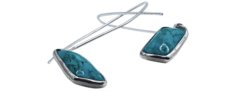 Silver drop earrings with turquoise stones, featuring a modern geometric design displayed side by side.