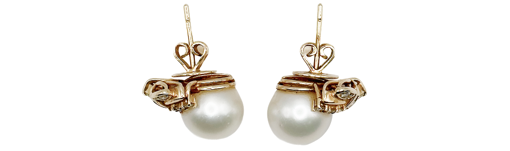 Pair of elegant pearl earrings with gold settings and intricate detailing, perfect for a sophisticated look.