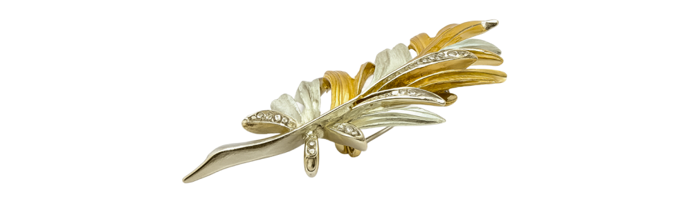 Keyword 1 two-tone gold leaf brooch with textured gold and silver details, elegant jewelry accessory for outfits.