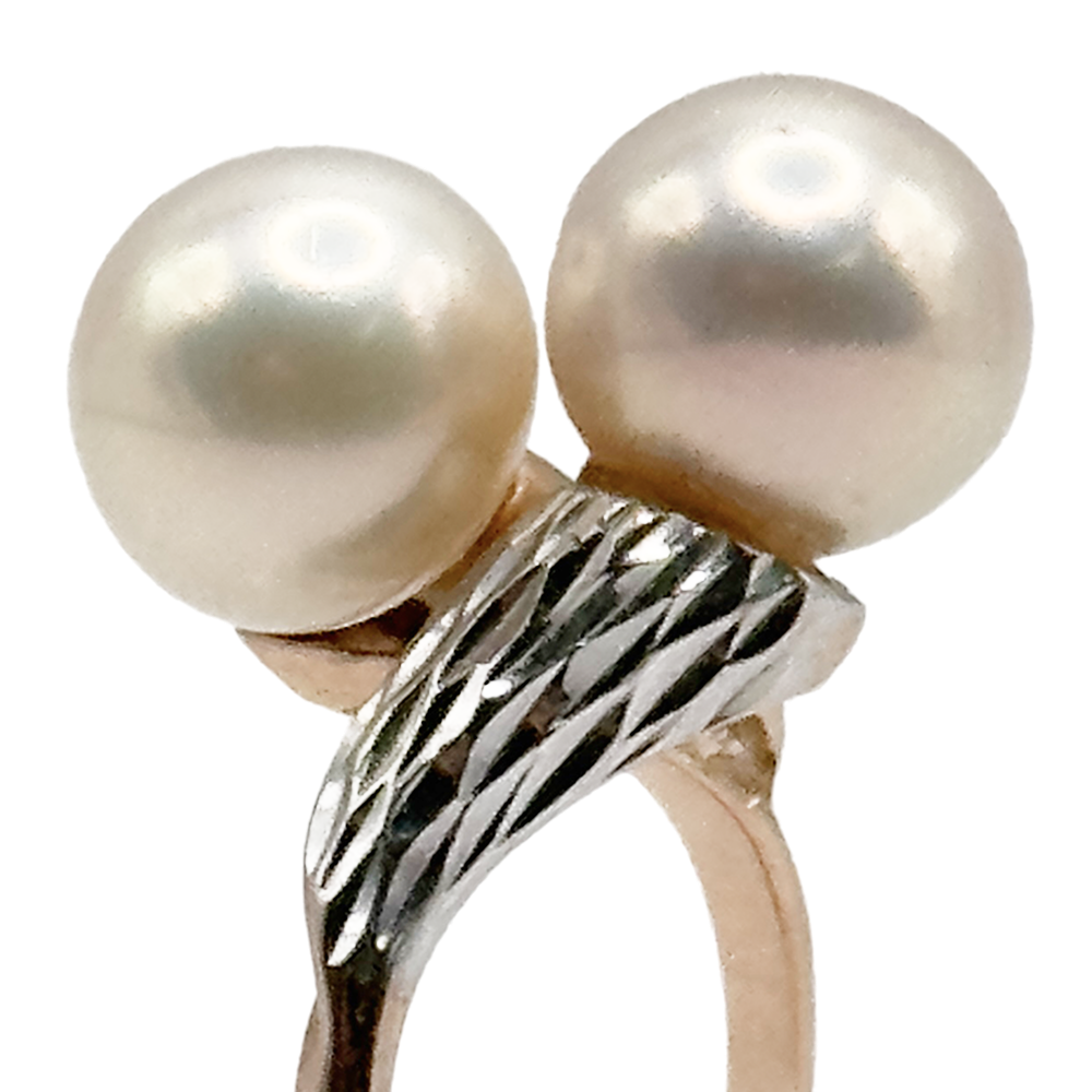 Gold-tone ring featuring two large, round pearls with a twisted, textured band.