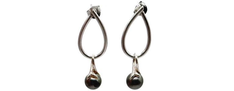 Pair of silver drop earrings with teardrop-shaped hoops and spherical accents at the bottom.