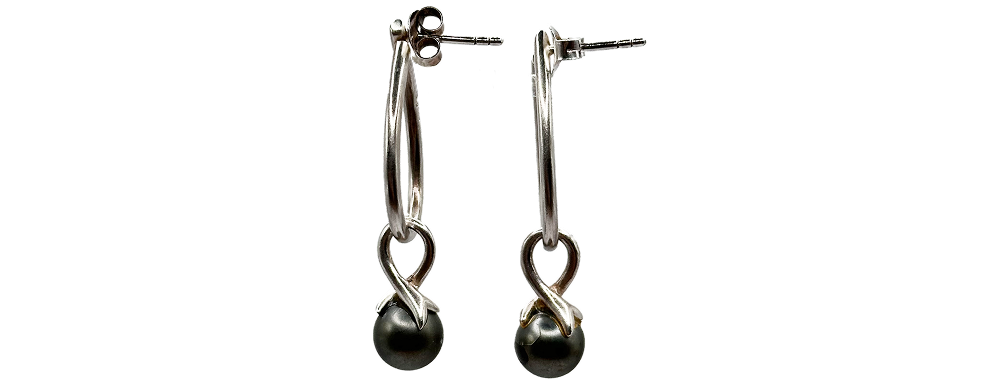 Pair of silver drop earrings featuring twisted hoops with dark spherical beads at the ends.