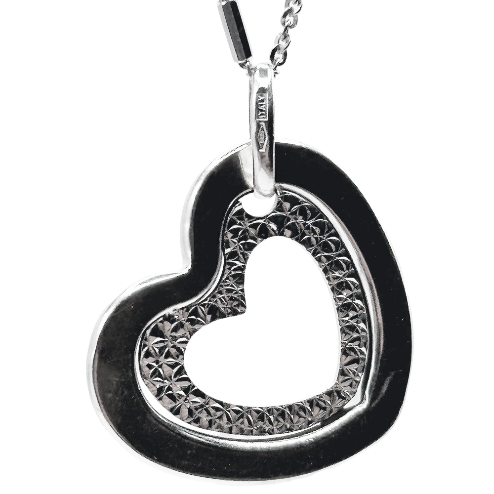 Silver heart pendant necklace with textured inner detailing, hanging from a delicate chain.