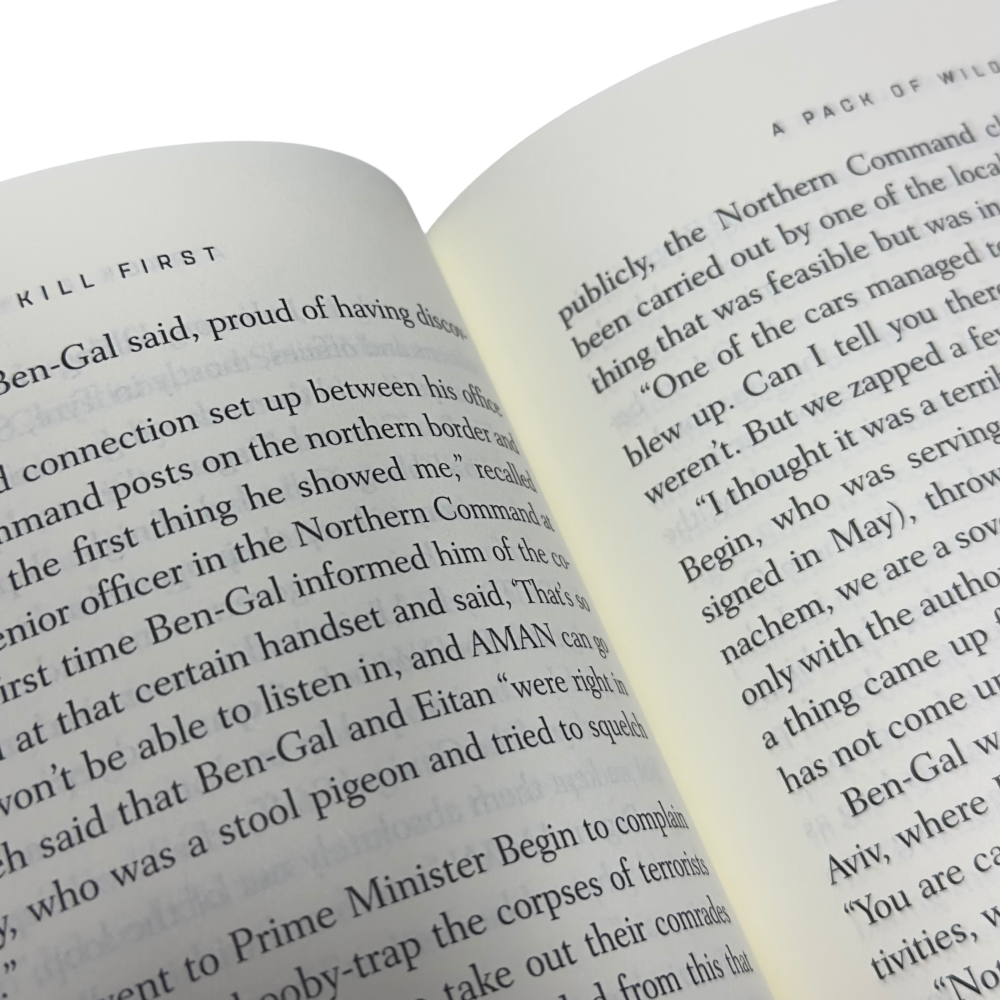 Close-up of open Rise and Kill First book showing partial text on its pages.